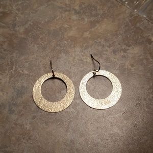 Golden earrings. Shimmering circles.